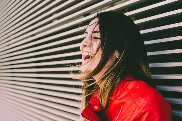 Young woman with real face, not model, laughing out loud with fl