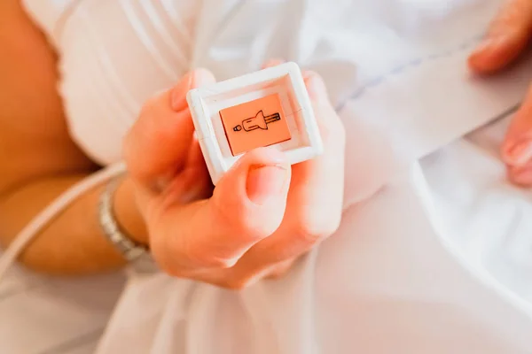 Old icon with the shape of a female nurse on the push button in