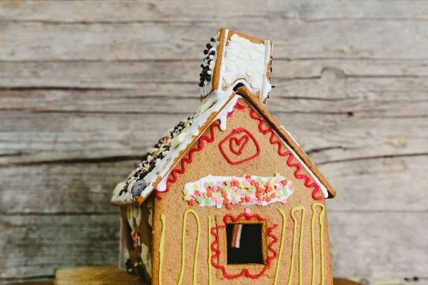 Gingerbread house decorated with colored sugar.