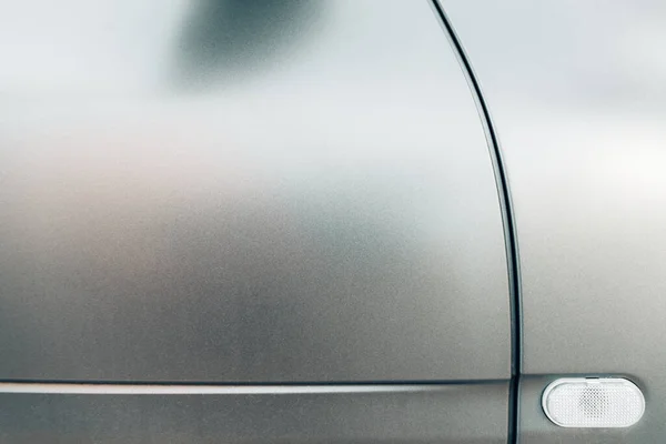 Modern lines in a metallic chassis design of car doors with matte paint.