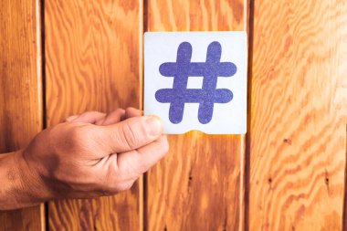 Hashtag # sembolünü parmaklarının arasında tutan kişi