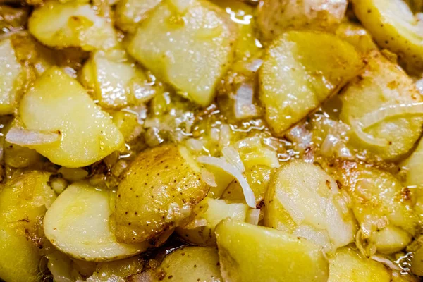 Typical Spanish dish made from potatoes and garlic, fried in a pan with olive oil, seen from above