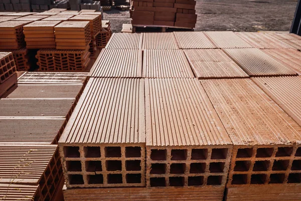 Pile of new bricks stacked to build a wall in a building supplies store.