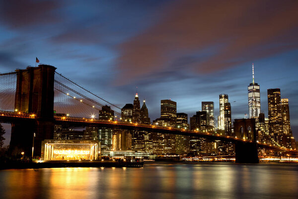 New York City Manhattan Downtown with Brooklyn Bridge at dusk