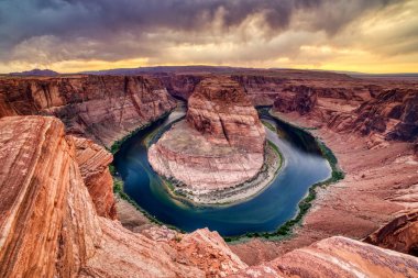 At nalı Bend batımında dramatik ile bulutlu Colorado Nehri üzerinde 