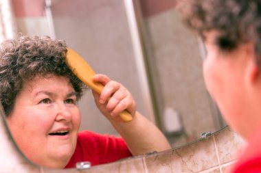 a mentally disabled woman combing through her hair clipart