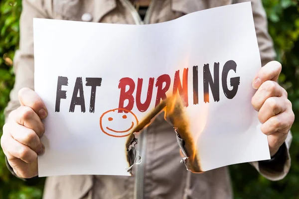 Woman Holding Burning Paper Sentence Fat Burning — Stock Photo, Image