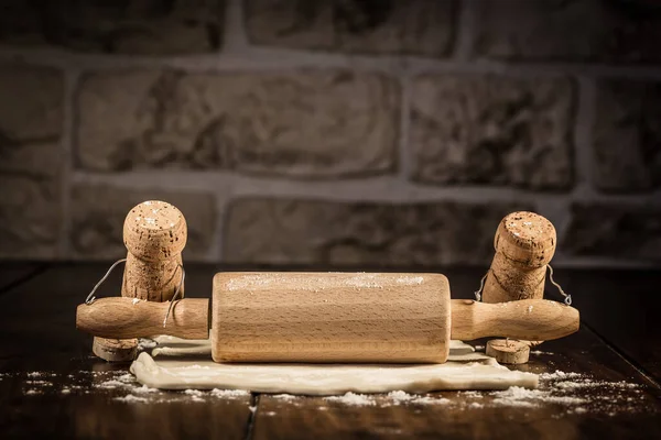 Concept baker to roll some pastry, wine cork figures