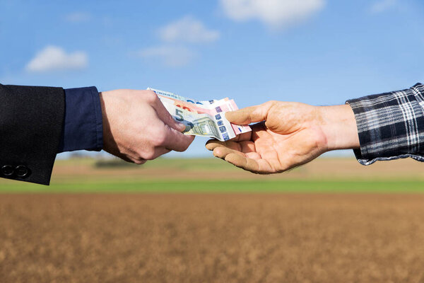 a businessman and farmer with a money transfer