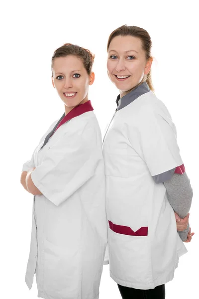 Duas Enfermeiras Sorrindo Para Espectador Isoladas Branco — Fotografia de Stock