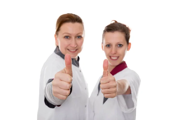 Duas Enfermeiras Apresentando Energia Sucesso Isoladas Branco — Fotografia de Stock