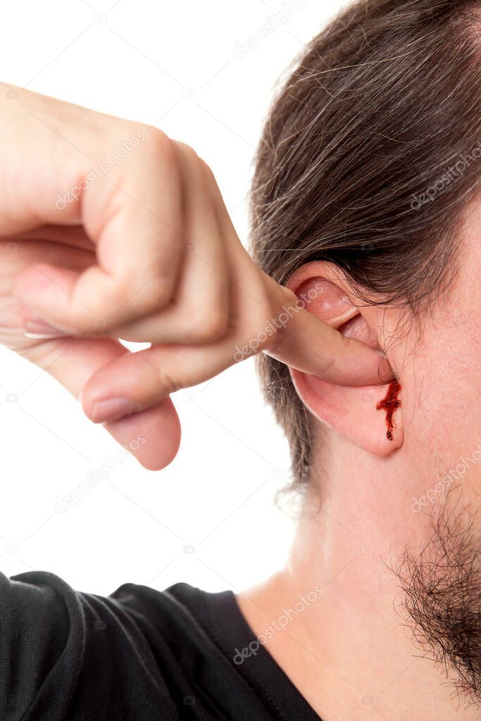 closeup man holding a finger in his ear with ear bleeding, isolated on white, concept noise and wounds