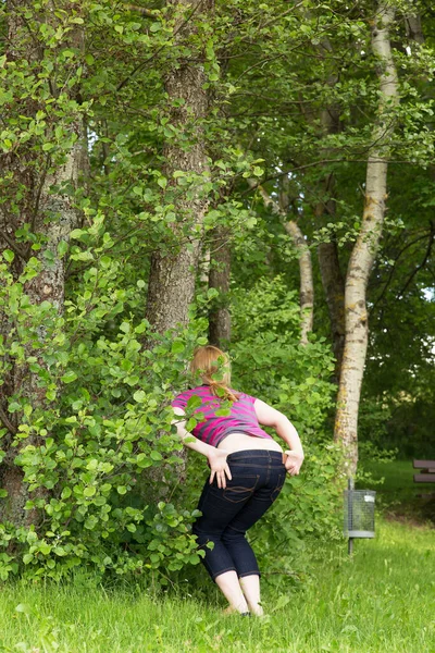 Vrouw Plassen Buiten Achter Struiken — Stockfoto