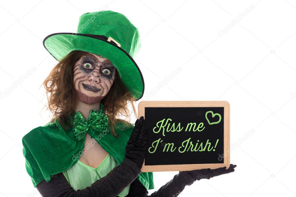 a green Leprechaun holding a slate with text Kiss me im irish isolated on white