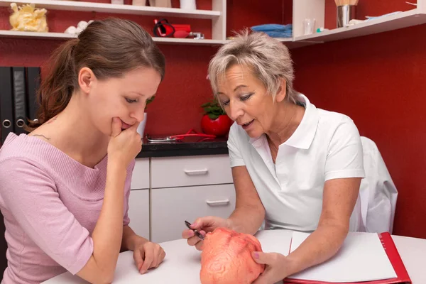 Female Mature Doctor Explaining Human Heart Younger Woman — Stock Photo, Image