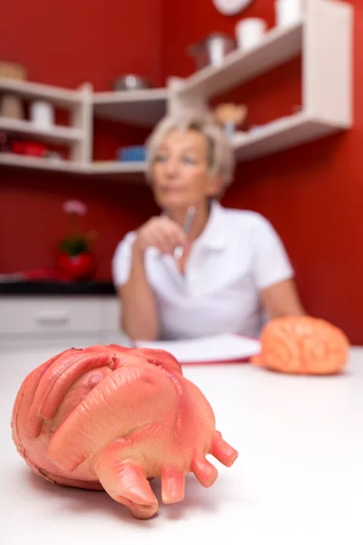 Female Mature Doctor Thinking Heart Diseases Having Continuing Medical Education — Stock Photo, Image