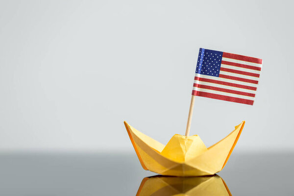 paper ship with usa flag, concept shipment or free trade agreement, travel