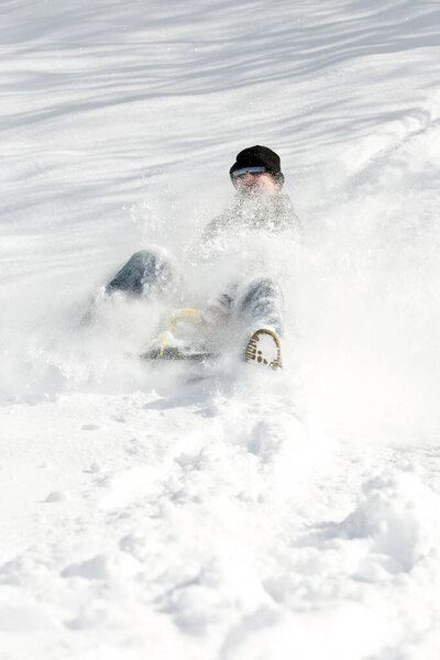 a man sledging in deep snow, concept sleigh ride and winter