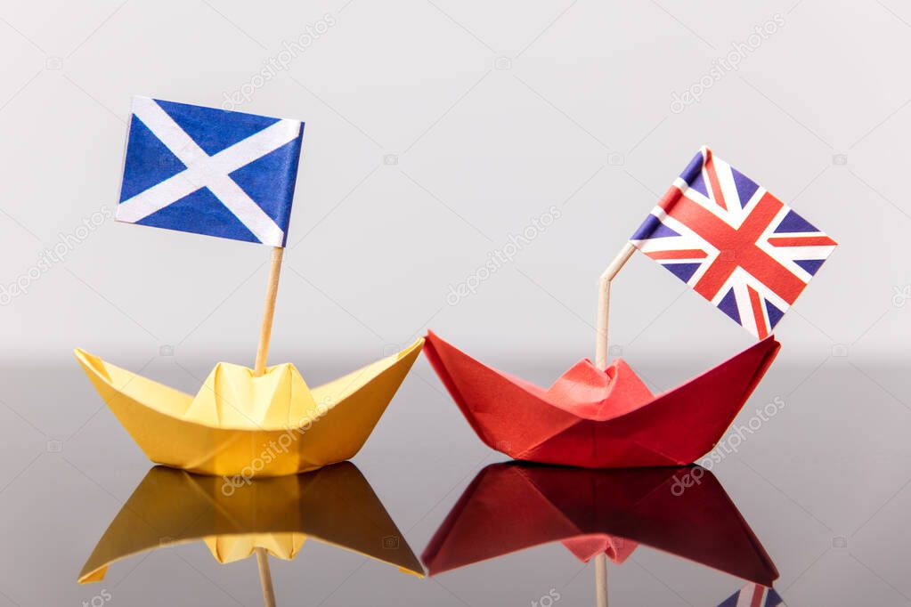 paper ship with british and scots flag, concept shipment or free trade agreement and membership of eu, independence referendum