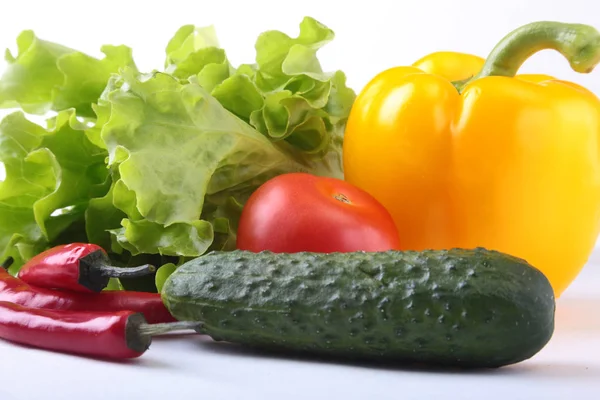 Assorted vegetables, fresh bell pepper, tomato, chilli pepper, cucumber and lettuce isolated on white background. Selective focus. — Stock Photo, Image