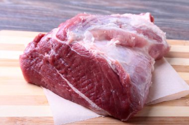 Otlar, sarımsak ve baharat pişirme için hazır ahşap tahta üzerinde çiğ domuz biftek. Seçici odak.