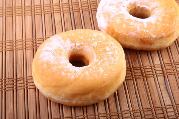 Homemade Doughnuts with Jelly filled and powdered sugar on Bamboo tablecloth. Selective focus. — Stock Photo, Image