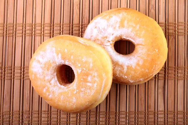 Homemade Doughnuts with Jelly filled and powdered sugar on Bamboo tablecloth. Selective focus. — Stock Photo, Image