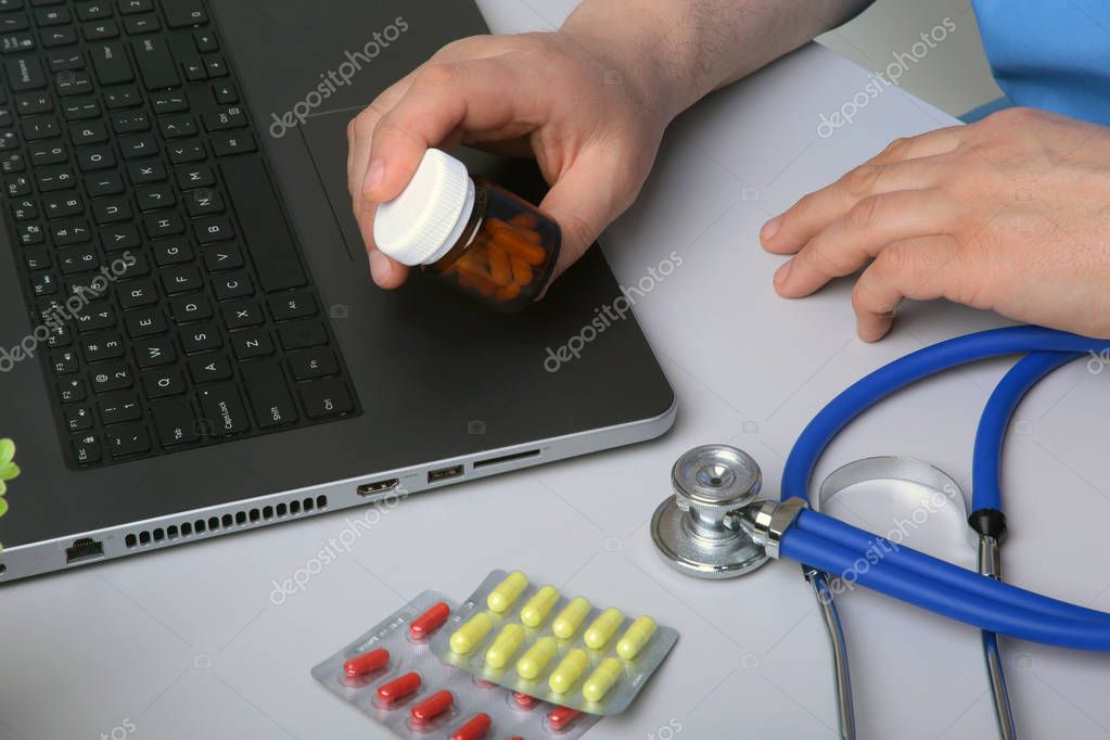 Doctor hand showing drug boxes at Office Desktop. Health care, Medical and Pharmacy Concept