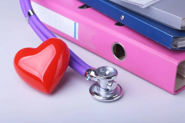 Folder file, stethoscope, red heart and RX prescription on the desk. blurred background. — Stock Photo, Image