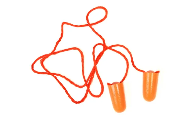 Orange öronproppen för arbete. Öronproppen att minska buller på en vit bakgrund . — Stockfoto