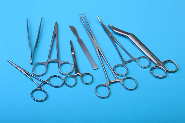 Close Up Surgical instruments and tools on blue mirror background. Selective focus. — Stock Photo, Image