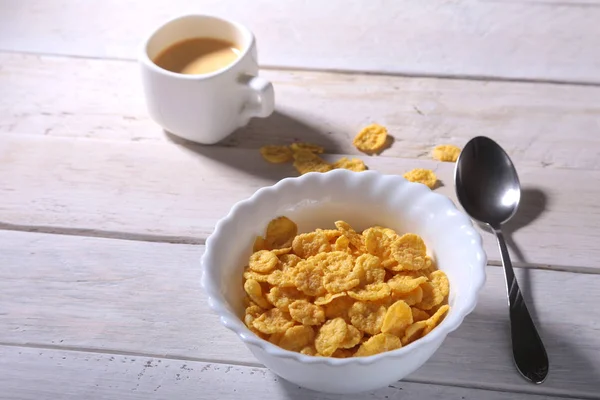 Corn Flakes cereal in a bowl and cap with espresso coffee. Morning breakfast. — Stock Photo, Image