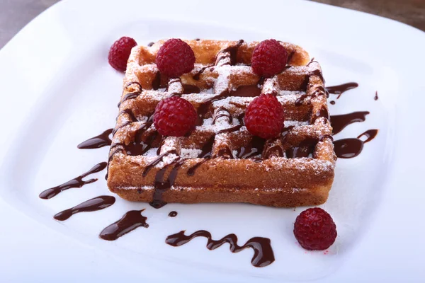 White plate with homemade belgian waffles with Sifting sugar powder over black background. — Stock Photo, Image