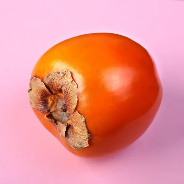 Fresh exotic fruits persimmon on a pink background. Fruit background. Top View. — Stock Photo, Image