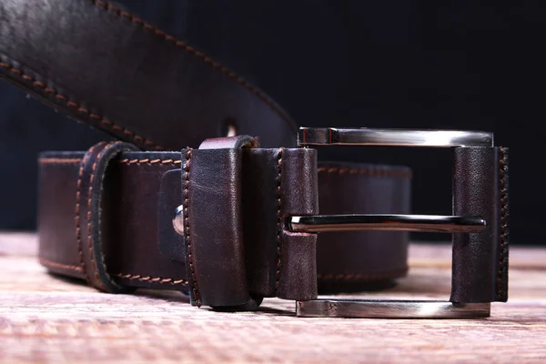 Men elegance leather belt on wooden table. — Stock Photo, Image