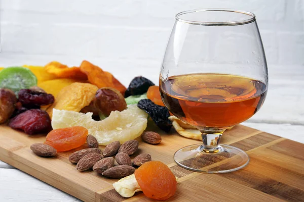 Mix of dried fruits and nuts on a dark wood background. tinting. selective focus. — Stockfoto