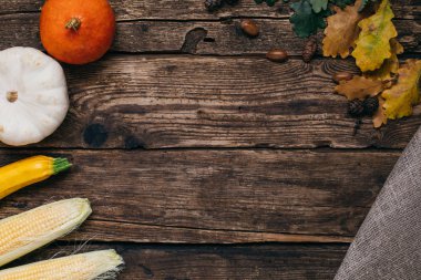 Sonbahar sebze: kabaklar ve Mısır ahşap bir zemin üzerine sarı yaprakları ile ana sayfa görünümü
