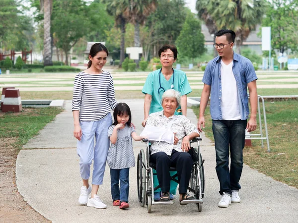 Happy Elderly Woman Talking Senior Nurse Her Family Park Walikng — Stock Photo, Image
