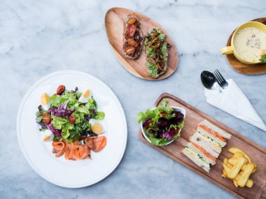 duman somon salata çorba ve kulüp sanwich ile üstten görünüm tablo.