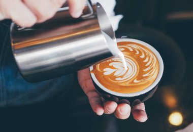 Barista kahve espresso makinesi vintage renk tonu kafede kahve dükkanı ile kahve latte sanat yapmak