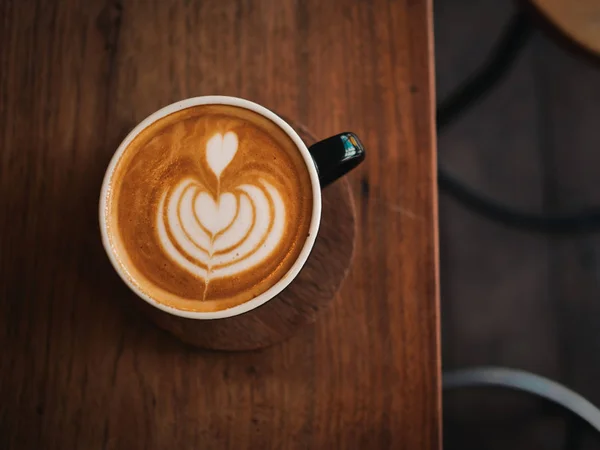 Coffee latte on the wood desk in cafe — Stock Photo, Image