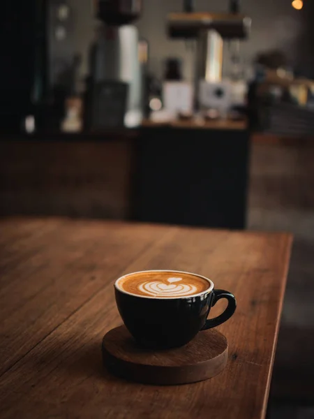 Coffee latte on the wood desk in cafe — Stock Photo, Image