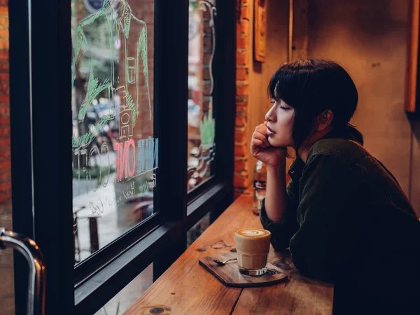 Asiatisk kvinna dricka kaffe i kaféet café — Stockfoto