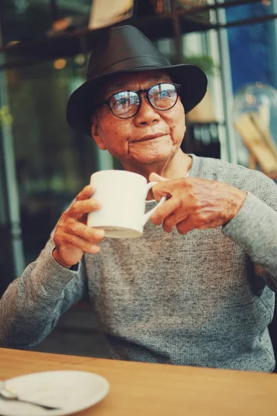 Asiatische senoir alter Mann Ruhestand Kaffee trinken im Café lächeln ein — Stockfoto