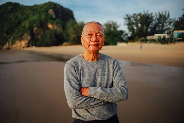 Portrait of Senior old man relax on the beach smile and happy fa