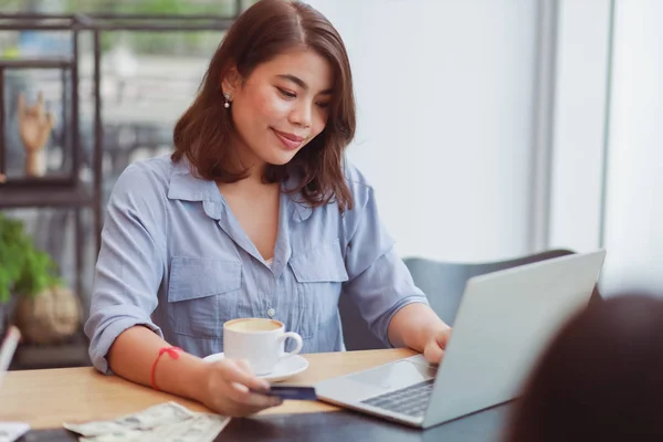 Asian woman using mobile phone with credit card and laptop compu — Stock Photo, Image