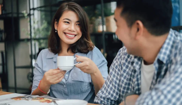 Asian woman in blue shirt  in cafe drinking coffee and talking w — Stock Photo, Image