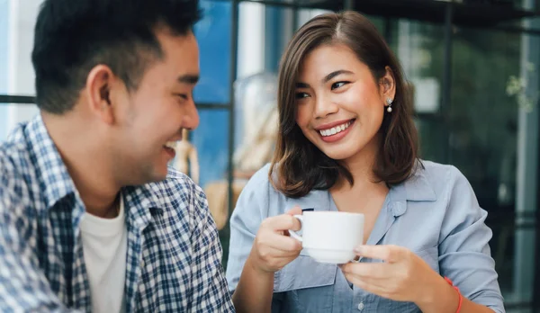 Asian woman in blue shirt  in cafe drinking coffee and talking w — Stock Photo, Image