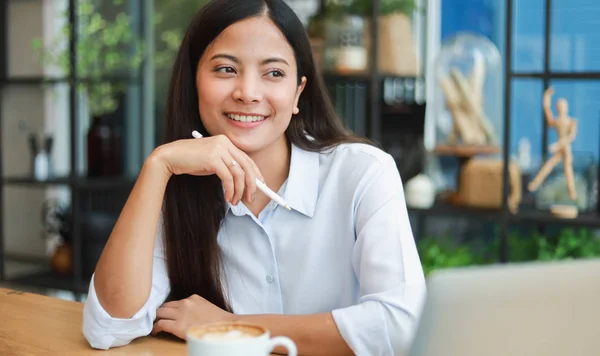 Asian woman in blue shirt working and drink coffee in coffee sho — Stock Photo, Image
