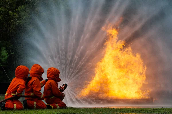 Firefighter spray water to fire burning car workshop fire traini — Stock Photo, Image